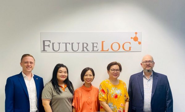 FutureLog team members standing together in celebration of the opening of FutureLog's new office in Singapore