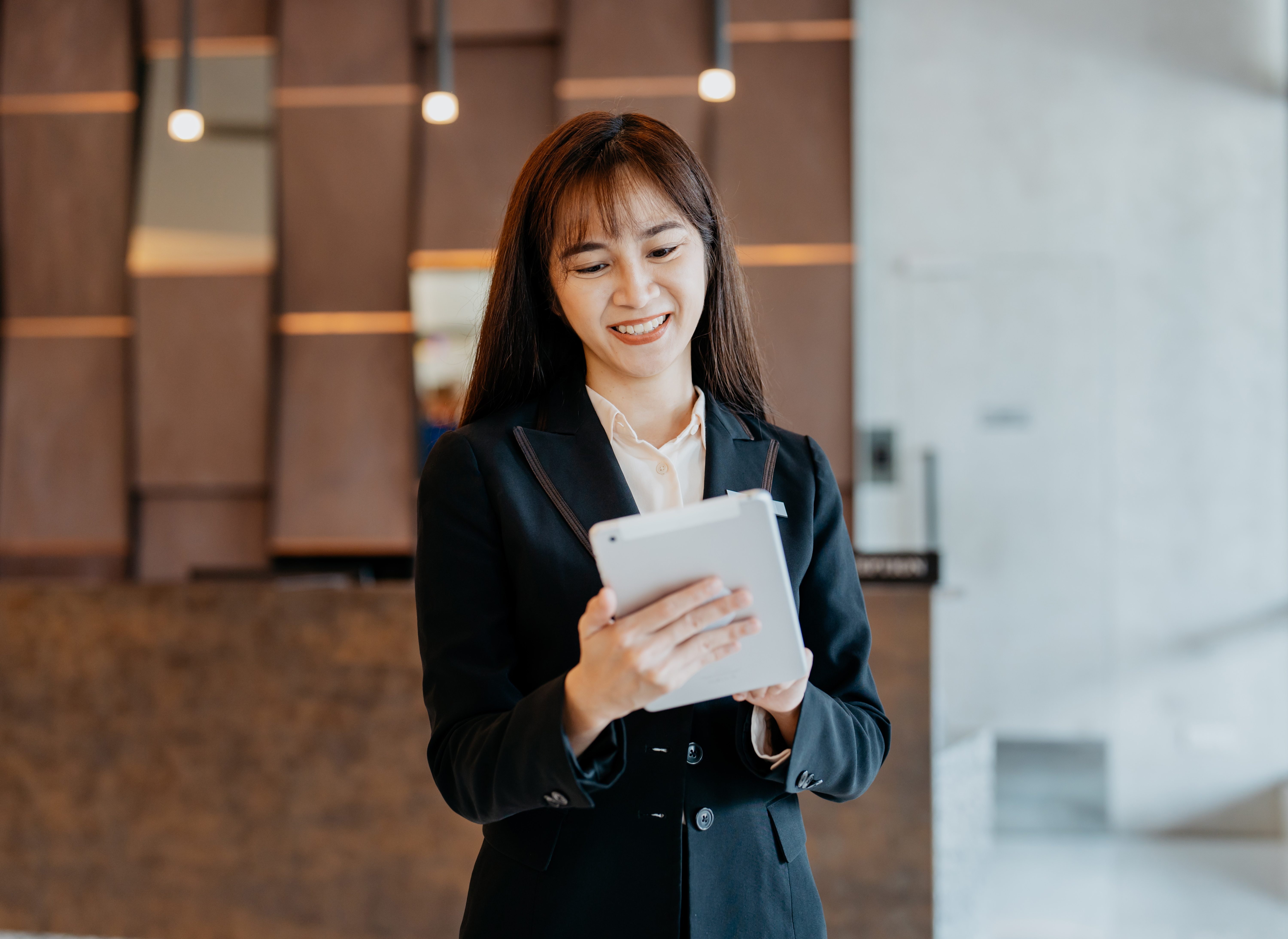 Woman holding a tablet contacting FutureLog